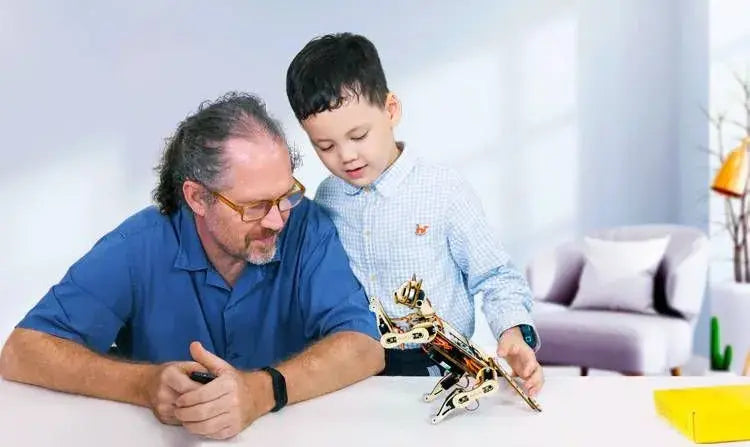 A dad and his son play with Petoi open source and programmable robot cat Nybble